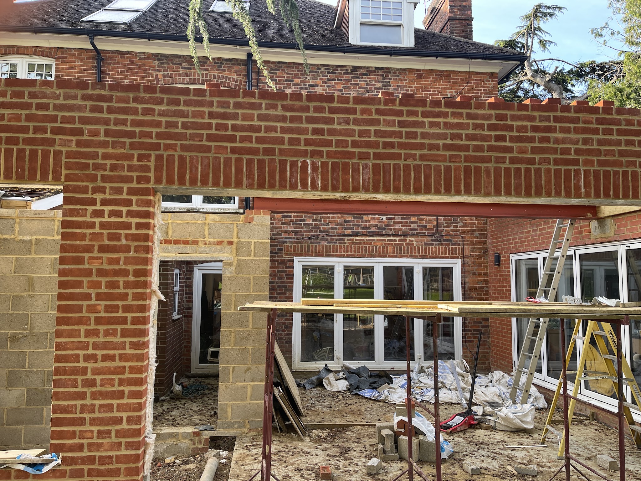 Rear extension in progress with red brick piers and a lintel course