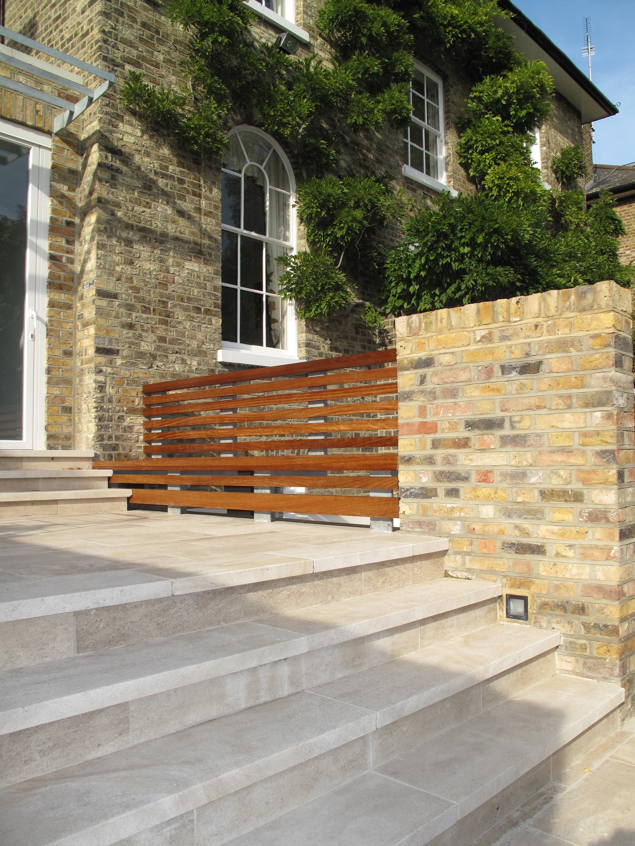 London stock brick wall beside new porcelain steps