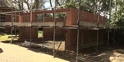 A brick extension surrounded by scaffolding